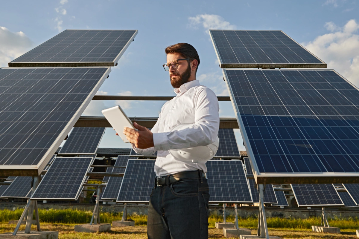 Businessman using tablet near solar panels